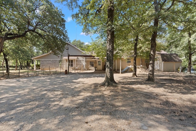 exterior space with an outdoor structure, fence, and a storage unit