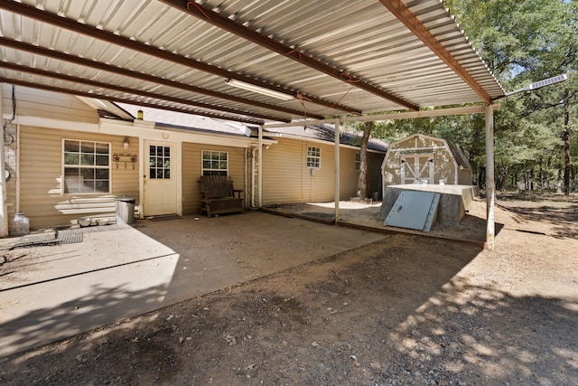 view of patio / terrace featuring a carport and a shed