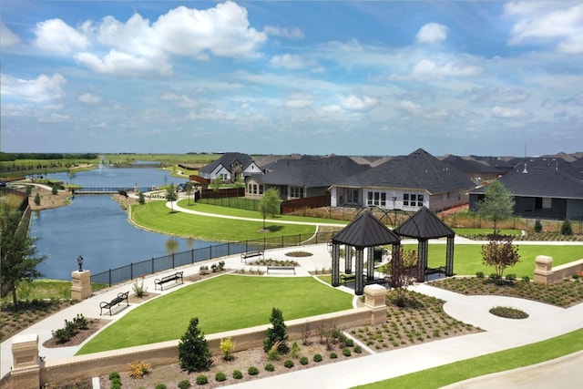 view of community with a water view, a yard, a residential view, and a gazebo