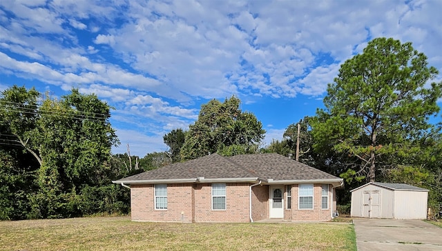 view of front of property with a shed and a front yard