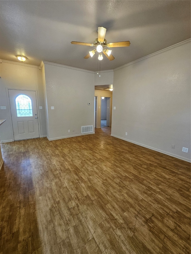 interior space with hardwood / wood-style floors, ornamental molding, and ceiling fan