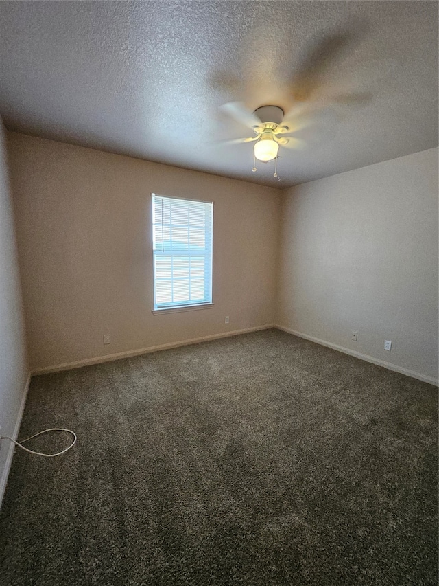 empty room with a textured ceiling, carpet flooring, and ceiling fan