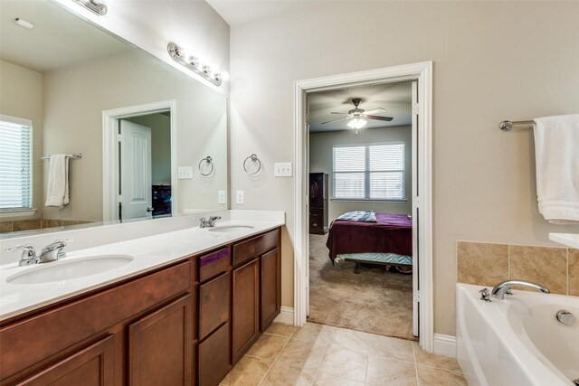 bathroom featuring vanity, ceiling fan, tile patterned flooring, and a bathing tub