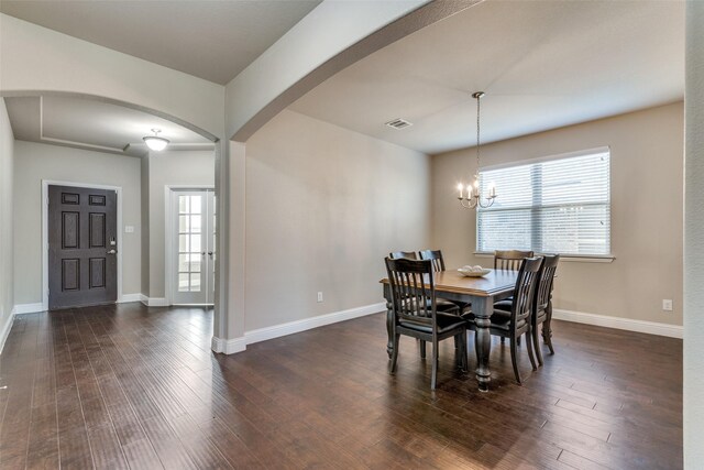 dining room featuring dark hardwood / wood-style flooring, a chandelier, and a wealth of natural light