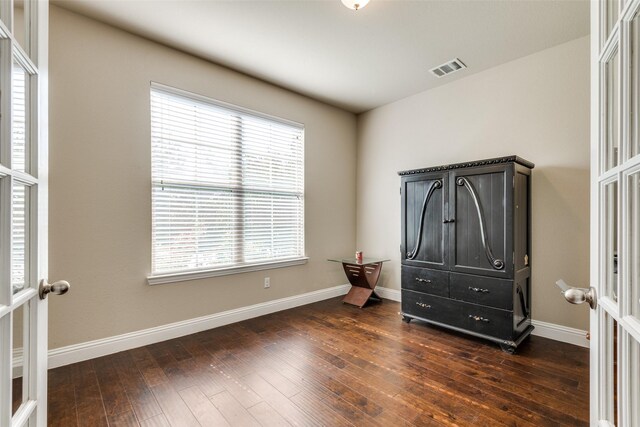 bedroom featuring french doors and dark hardwood / wood-style floors