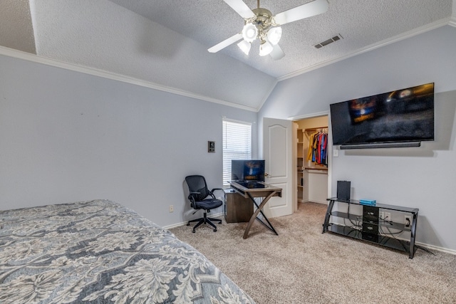 bedroom with lofted ceiling, light carpet, a walk in closet, ceiling fan, and a closet