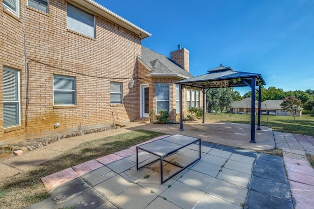 back of house featuring a gazebo and a patio