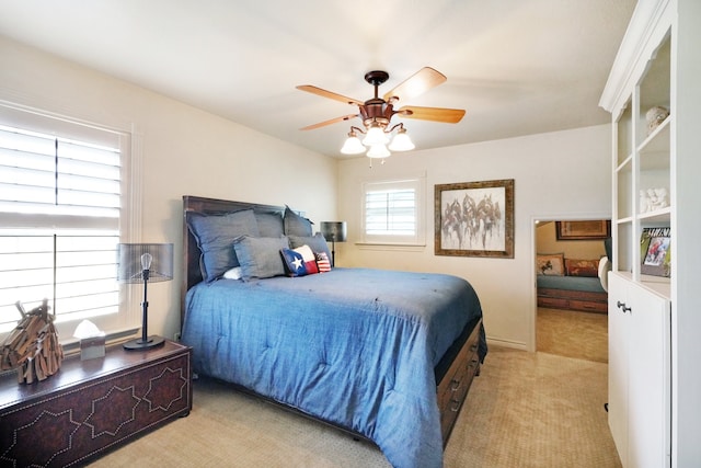 bedroom featuring light carpet and ceiling fan