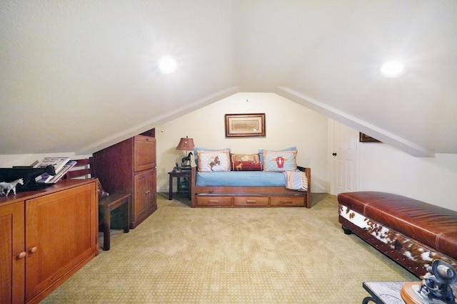 carpeted bedroom featuring vaulted ceiling