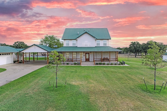 view of front of home with a garage, a carport, a yard, and a porch