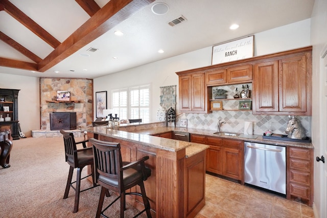 kitchen featuring a breakfast bar, sink, kitchen peninsula, dishwasher, and backsplash