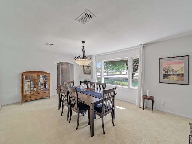 dining area with light colored carpet