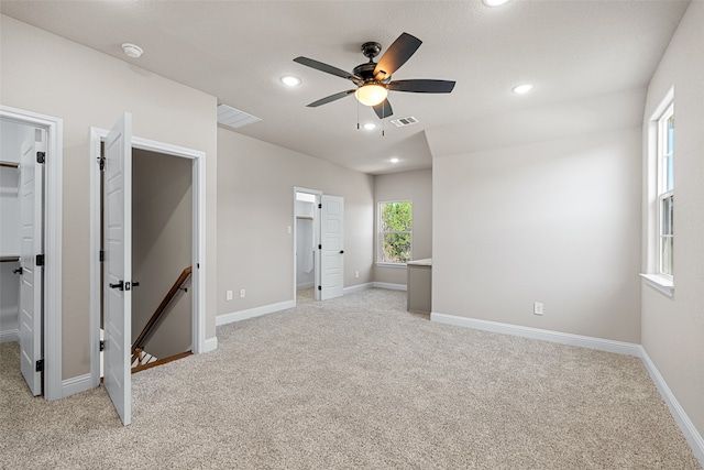 carpeted empty room featuring ceiling fan