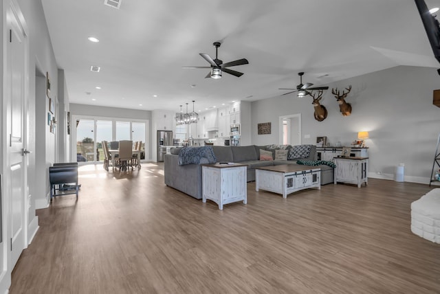 living room with ceiling fan and wood-type flooring