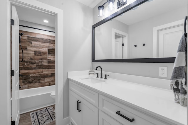 full bathroom with toilet,  shower combination, wood finished floors, and vanity