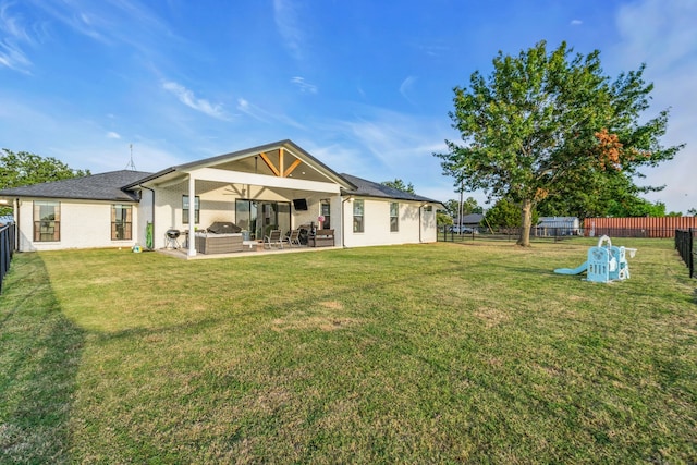 back of house with a patio, a fenced backyard, brick siding, an outdoor living space, and a yard