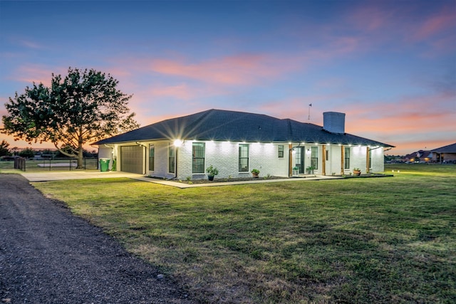 view of front of property featuring a lawn and a garage