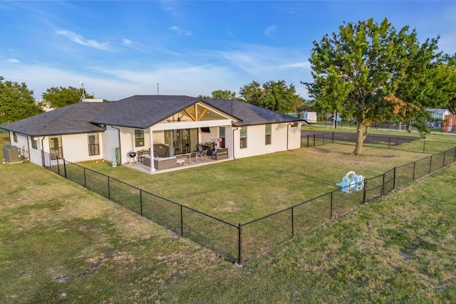 rear view of house with a patio area, a fenced backyard, a lawn, and central AC