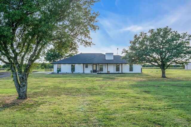 ranch-style home with a front lawn