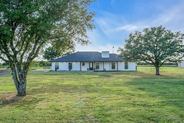 single story home featuring a front yard and a chimney