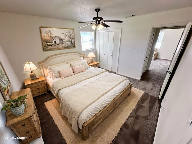 carpeted bedroom featuring a closet, a textured ceiling, and ceiling fan