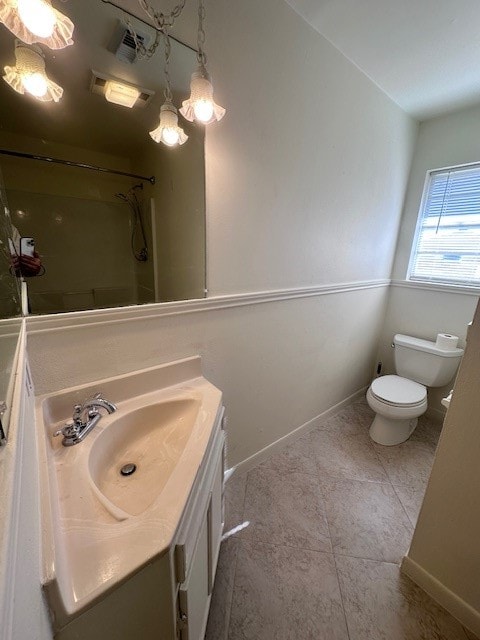 bathroom featuring vanity, toilet, a shower, and tile patterned flooring