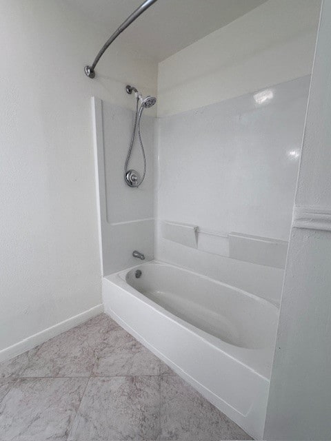 bathroom with tile patterned floors and bathing tub / shower combination