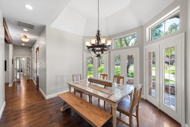 dining room featuring dark hardwood / wood-style flooring, high vaulted ceiling, an inviting chandelier, and french doors