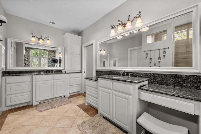 bathroom featuring a wealth of natural light, double vanity, and tile patterned floors