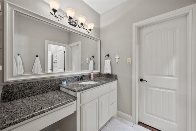 bathroom featuring tile patterned flooring and vanity