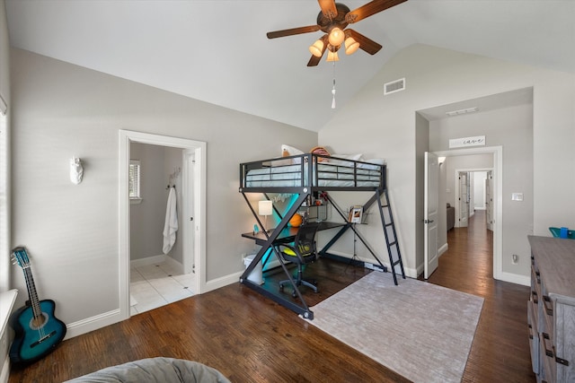 bedroom featuring ceiling fan, connected bathroom, lofted ceiling, and wood-type flooring