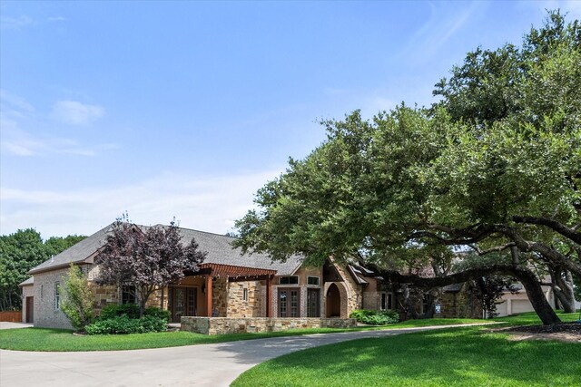 view of front of property featuring a garage and a front lawn