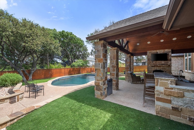 exterior space with a patio, a gazebo, an outdoor stone fireplace, and a fenced in pool