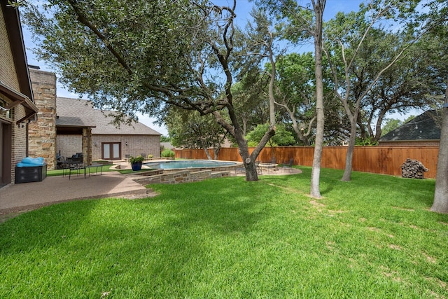 view of yard with a fenced in pool and a patio area