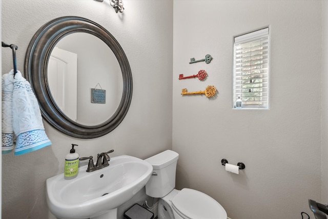 bathroom featuring sink and toilet