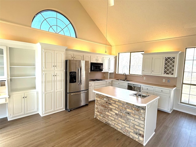 kitchen with dark wood-style floors, black appliances, light countertops, and white cabinetry