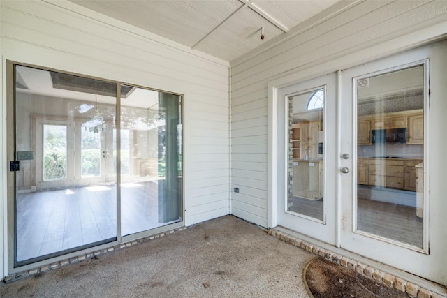 unfurnished sunroom featuring french doors