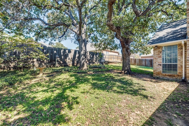 view of yard with a fenced backyard