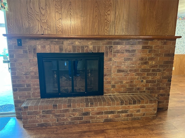 interior details featuring hardwood / wood-style floors and wooden walls