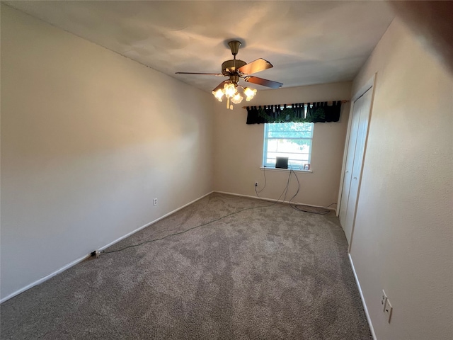 empty room with ceiling fan and carpet flooring