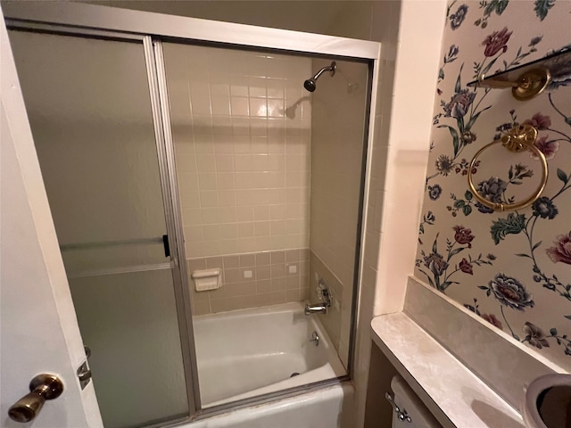 bathroom featuring vanity and enclosed tub / shower combo