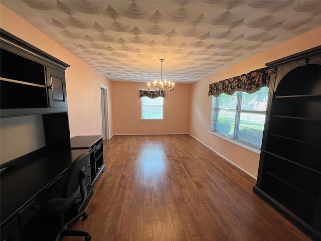 unfurnished office with wood-type flooring and a chandelier