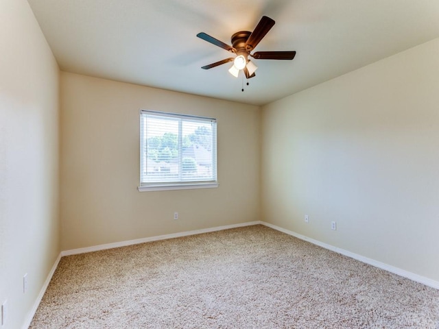 unfurnished room featuring ceiling fan and baseboards