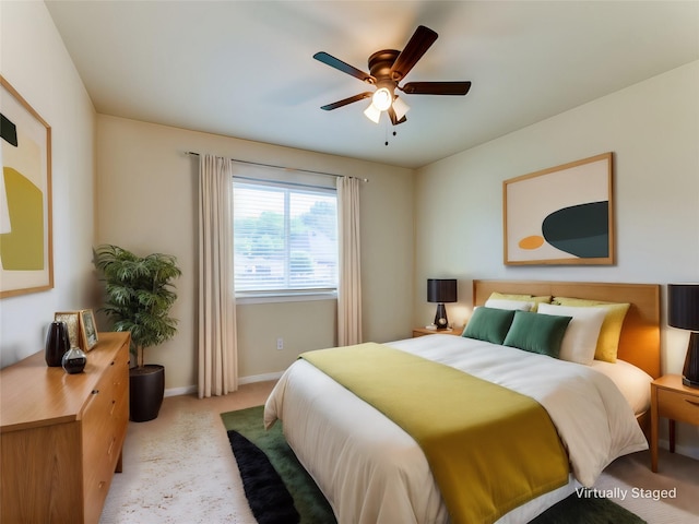 bedroom with a ceiling fan, carpet flooring, and baseboards