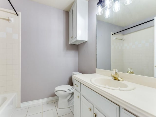 bathroom featuring toilet, vanity, baseboards,  shower combination, and tile patterned floors