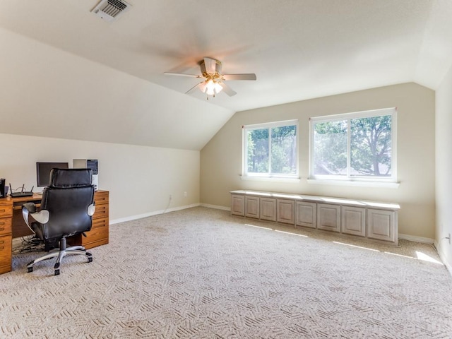 office area with light carpet, baseboards, visible vents, and vaulted ceiling