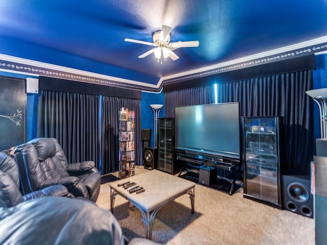 cinema room featuring a ceiling fan, carpet, beverage cooler, and crown molding