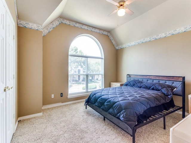 bedroom with lofted ceiling, baseboards, ceiling fan, and carpet