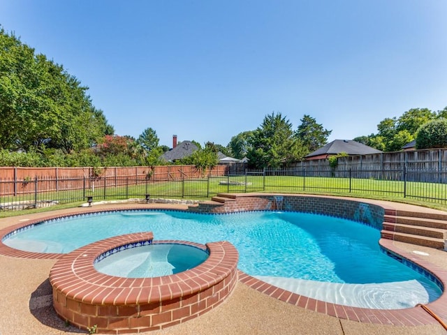 view of pool with a fenced backyard, a pool with connected hot tub, and a yard