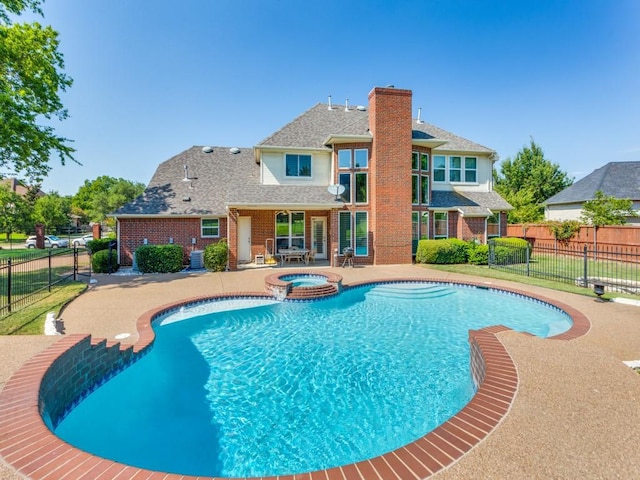 view of swimming pool with central air condition unit, a fenced backyard, a pool with connected hot tub, and a patio